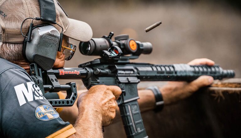 Competitor shooting a rifle stage at USPSA Multigun
