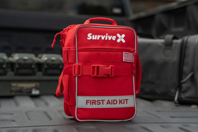 SurviveX Large range first aid kit opened flat showing labeled, color-coded compartments